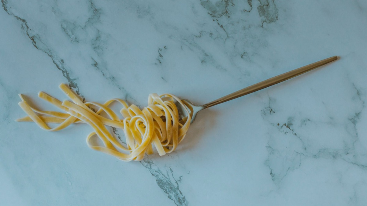 A close-up shot showing the perfect firm texture of al dente cooked pasta.