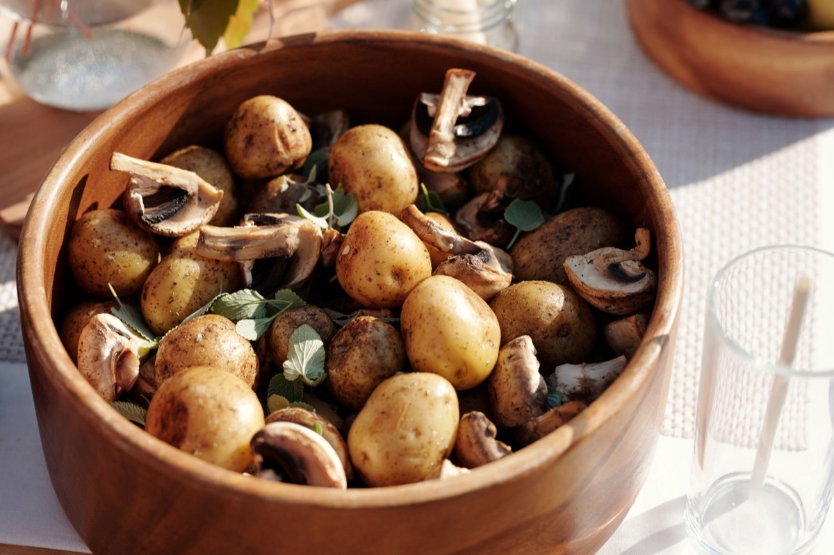 Sliced raw potatoes in a glass bowl to absorb excess salt from soup.