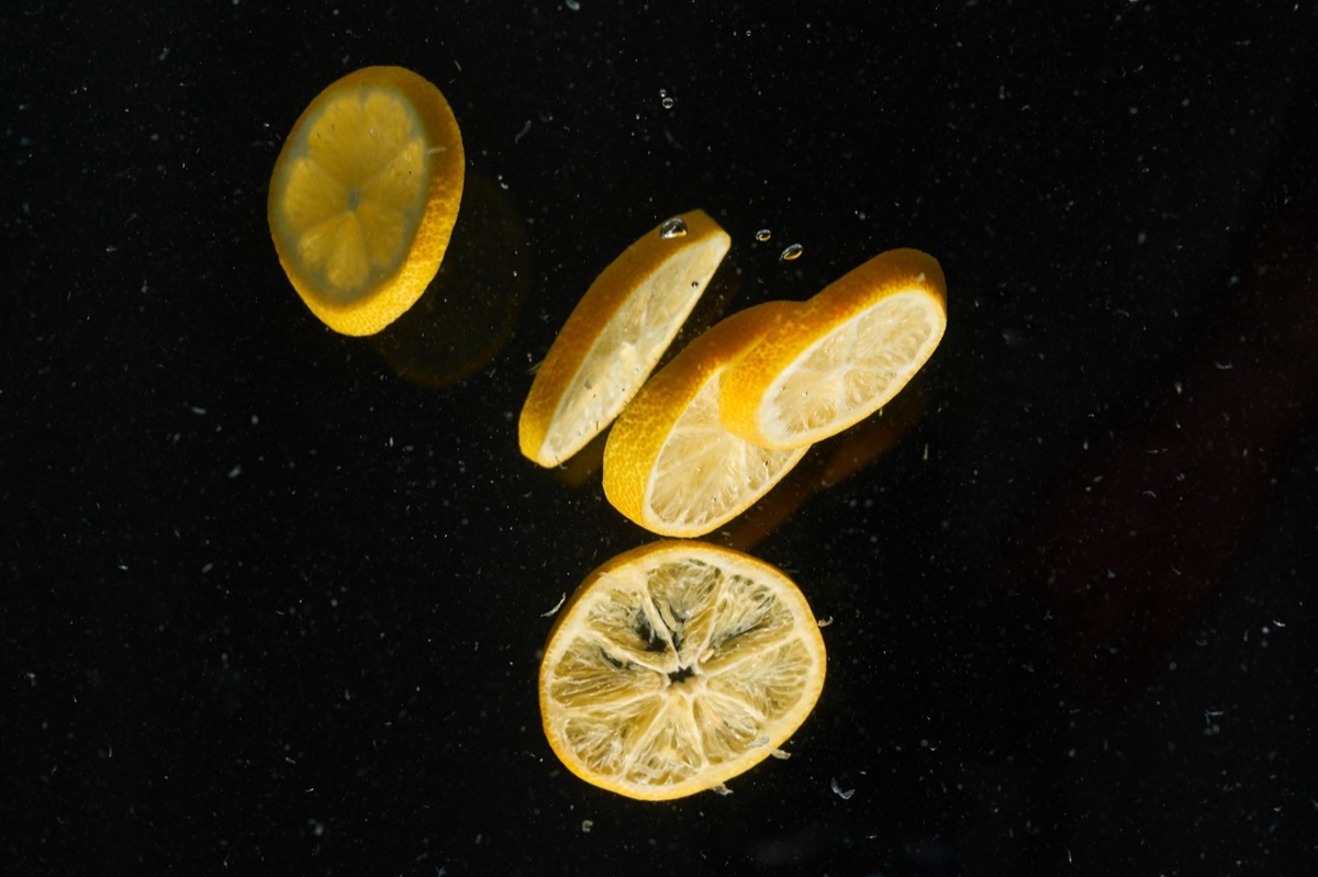 Fresh lemon slices used to brighten and balance salty flavors.