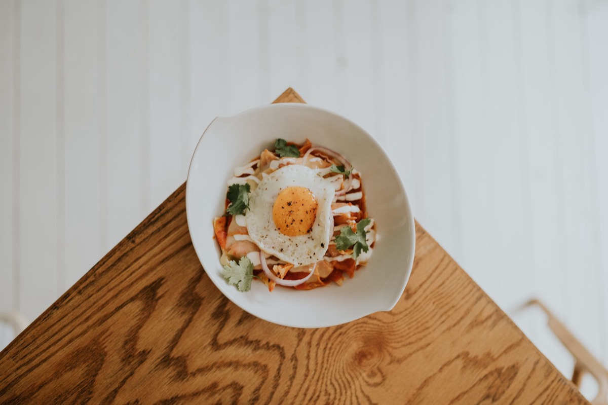A bowl of kimchi fried rice topped with a sunny-side up egg
